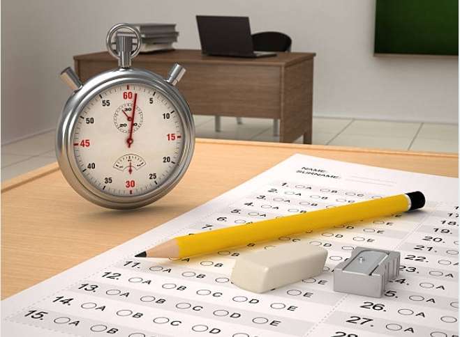 *Stopwatch, test sheet, pencil, and eraser on a desk for a timed exam.