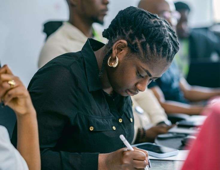 Female student writing during a CELPIP practice test